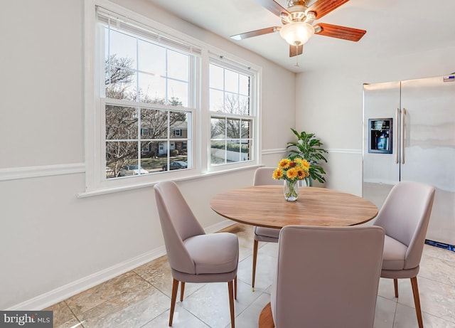 dining area featuring a ceiling fan and baseboards