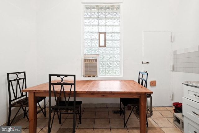 dining area featuring light tile patterned flooring and cooling unit