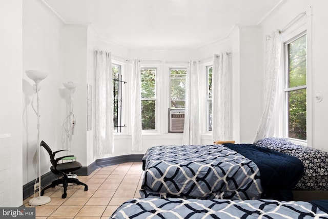 bedroom with multiple windows, cooling unit, crown molding, and tile patterned floors