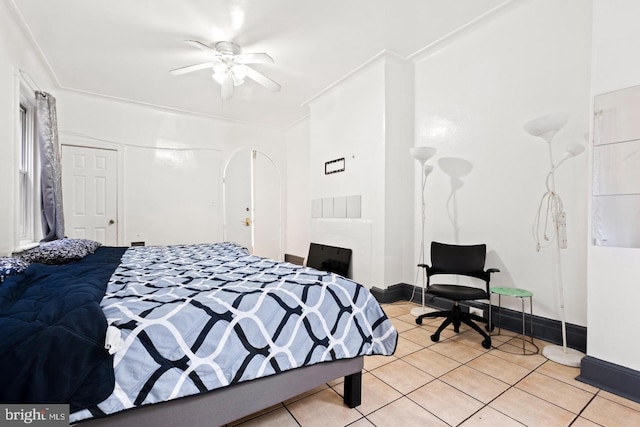 tiled bedroom featuring a closet and ceiling fan