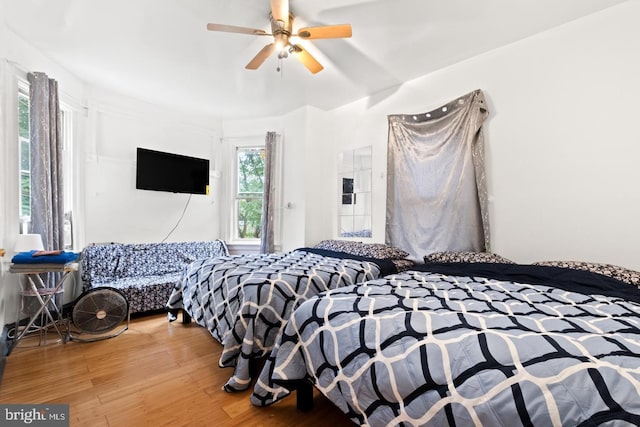 bedroom with ceiling fan and hardwood / wood-style floors