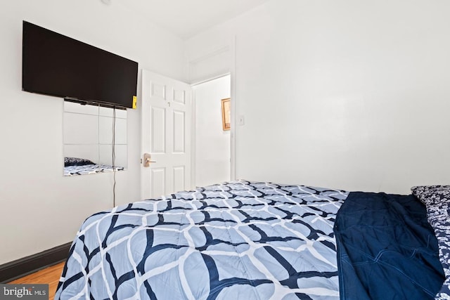 bedroom with wood-type flooring