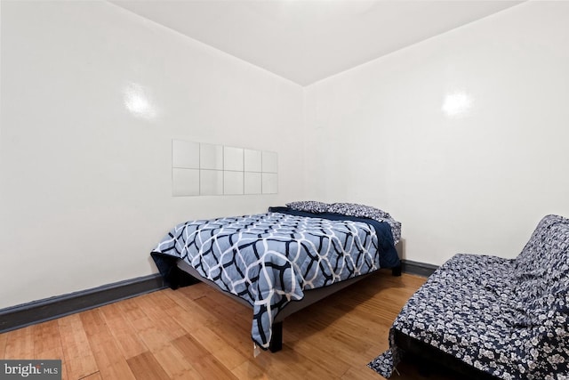 bedroom with hardwood / wood-style floors