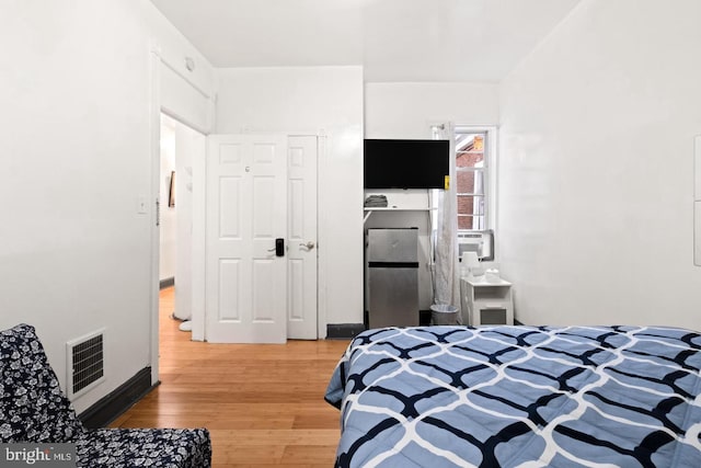 bedroom with hardwood / wood-style flooring