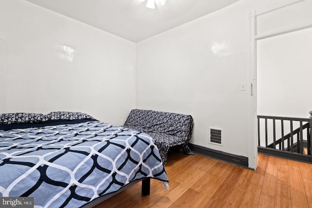 bedroom with hardwood / wood-style floors