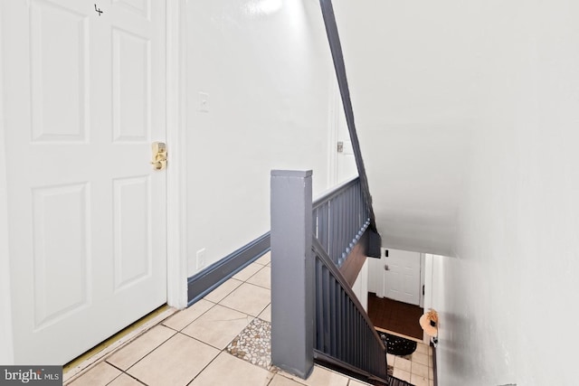 staircase featuring tile patterned floors