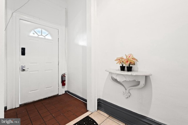 entrance foyer featuring dark tile patterned flooring