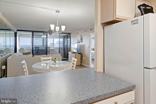 10300 Coastal Hwy Unit 104, Ocean City, MD 21842 - dining space with a textured ceiling, visible vents, and an inviting chandelier