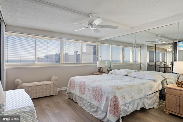 10300 Coastal Hwy Unit 104, Ocean City, MD 21842 - bedroom featuring light wood finished floors, baseboards, and a textured ceiling