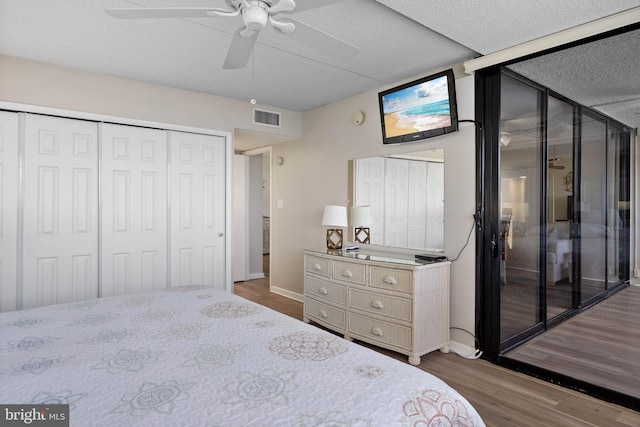 10300 Coastal Hwy Unit 104, Ocean City, MD 21842 - bedroom featuring a closet, visible vents, dark wood-type flooring, a ceiling fan, and baseboards