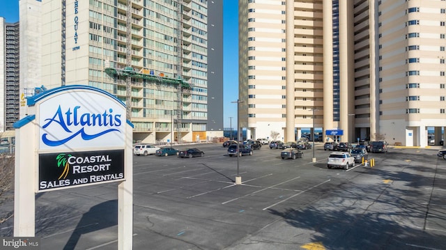 view of property featuring uncovered parking and a view of city