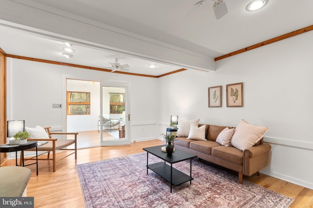 living room featuring beam ceiling, light hardwood / wood-style floors, and ceiling fan