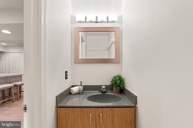 bathroom with vanity and hardwood / wood-style flooring