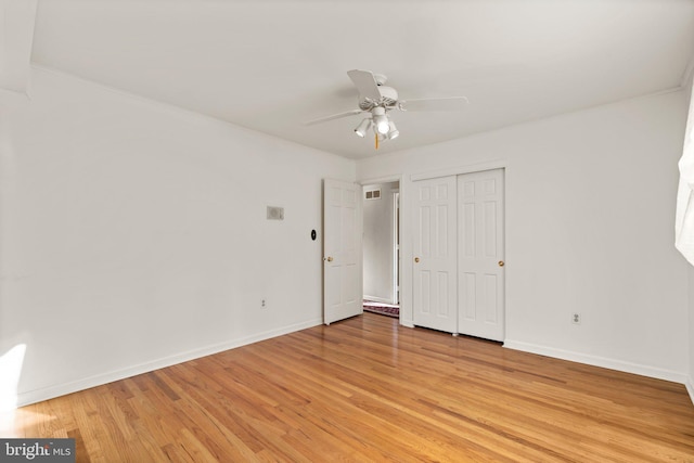 unfurnished bedroom featuring a closet, ceiling fan, and light hardwood / wood-style flooring