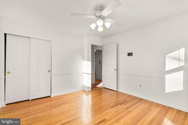 unfurnished bedroom featuring a closet, ceiling fan, and light wood-type flooring