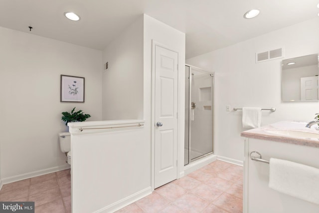 bathroom with toilet, vanity, and walk in shower