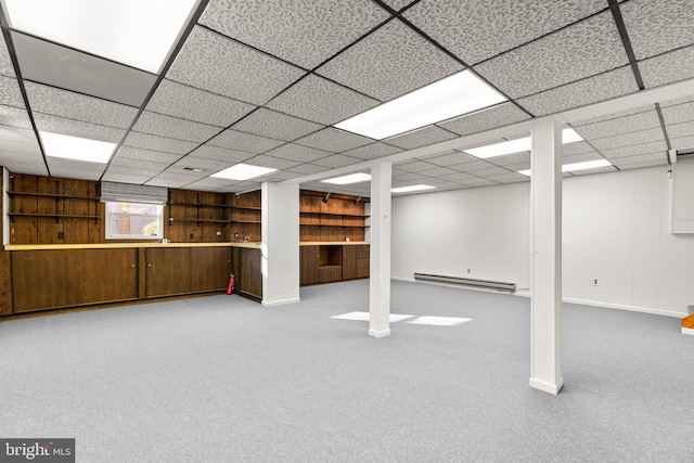 basement with carpet floors and a baseboard heating unit