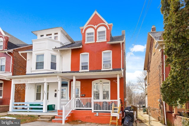 view of front of property with a porch and cooling unit