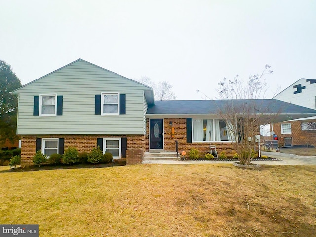 split level home with a front lawn and a carport