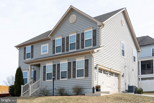 traditional home featuring an attached garage and central AC