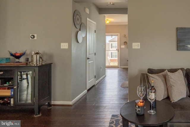 hall with baseboards and dark wood-style flooring