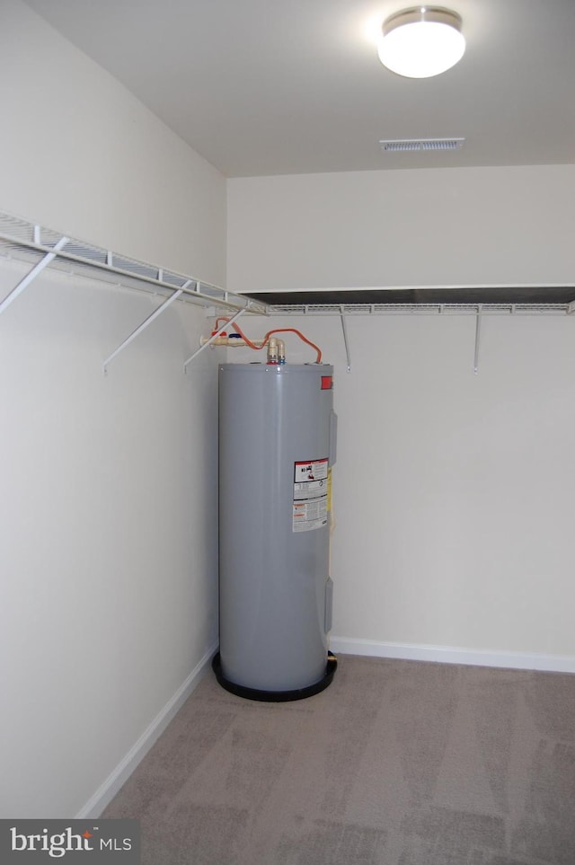 utility room featuring water heater