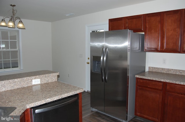 kitchen with dark wood-style flooring, decorative light fixtures, visible vents, appliances with stainless steel finishes, and a chandelier