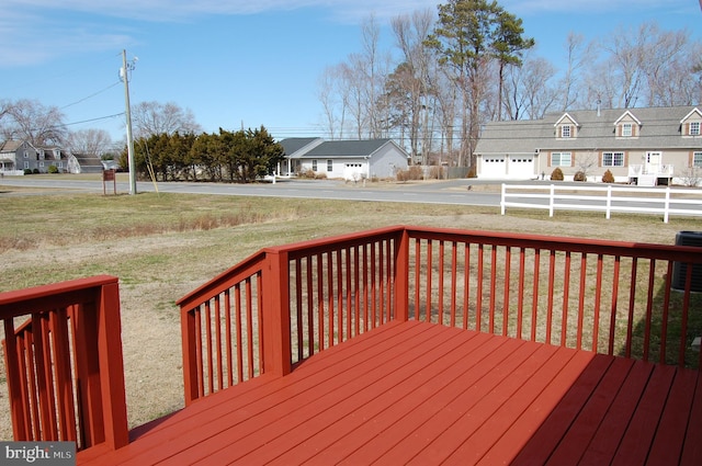 wooden terrace with a residential view, a lawn, and fence