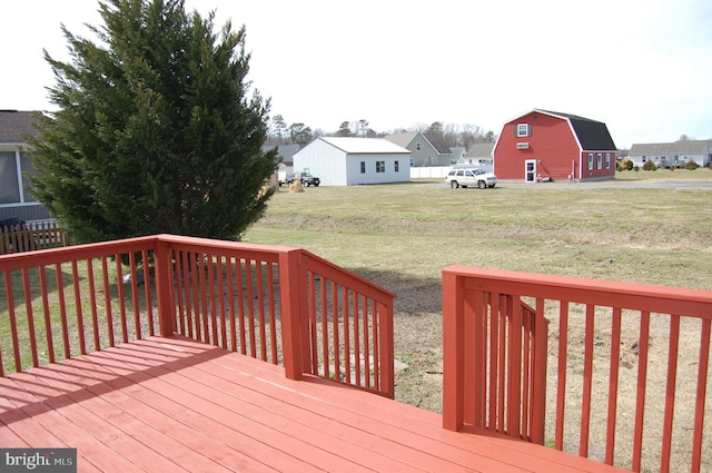 wooden deck featuring a lawn and a residential view