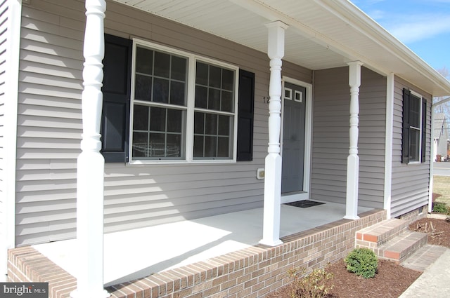 view of exterior entry with covered porch