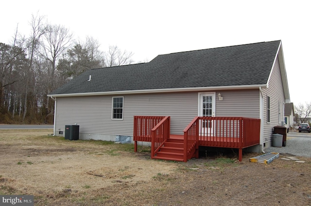 back of house featuring central air condition unit, crawl space, a wooden deck, and roof with shingles