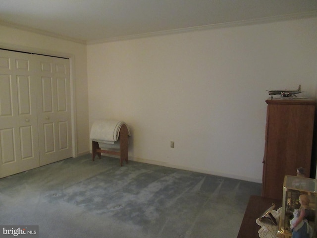 unfurnished bedroom featuring dark carpet, ornamental molding, and a closet