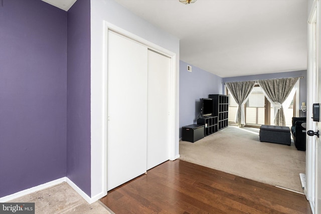 interior space featuring dark wood-style flooring and baseboards