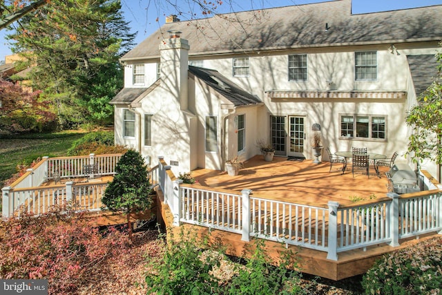 rear view of property with a wooden deck