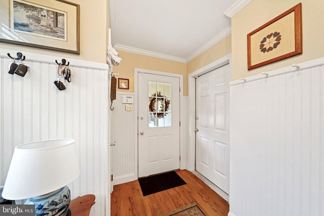 doorway to outside featuring hardwood / wood-style floors and crown molding