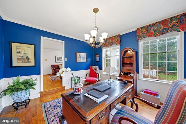 office area featuring an inviting chandelier, wood-type flooring, and ornamental molding