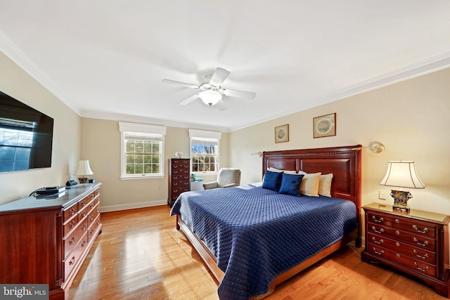 bedroom featuring ceiling fan, light wood-type flooring, and crown molding