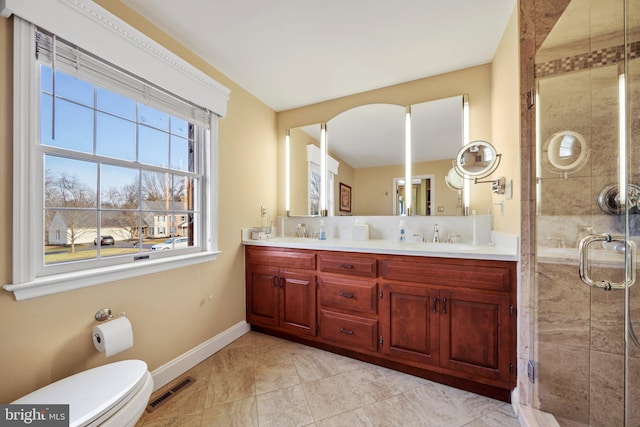 bathroom with vanity, toilet, and walk in shower