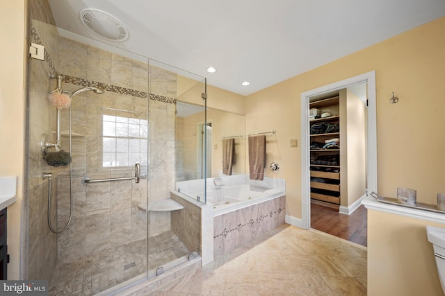 bathroom featuring shower with separate bathtub