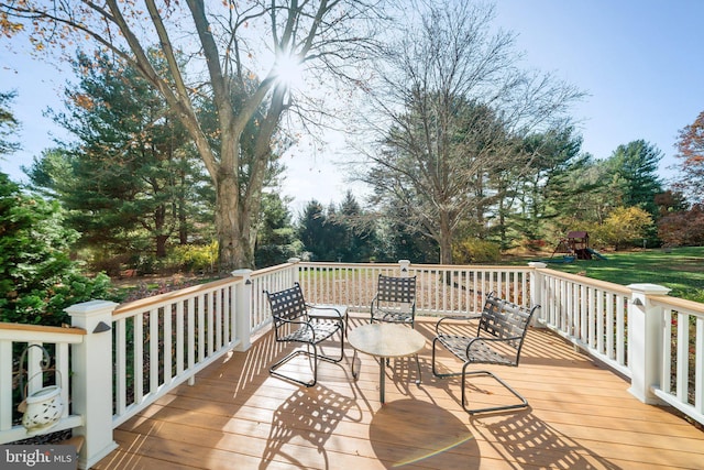 wooden deck featuring a playground