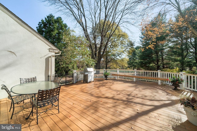 wooden terrace with a grill