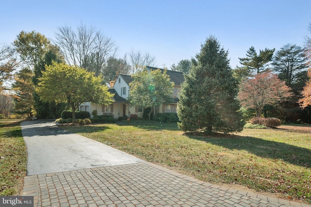 obstructed view of property featuring a front yard