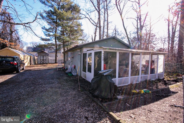 view of side of property featuring a sunroom