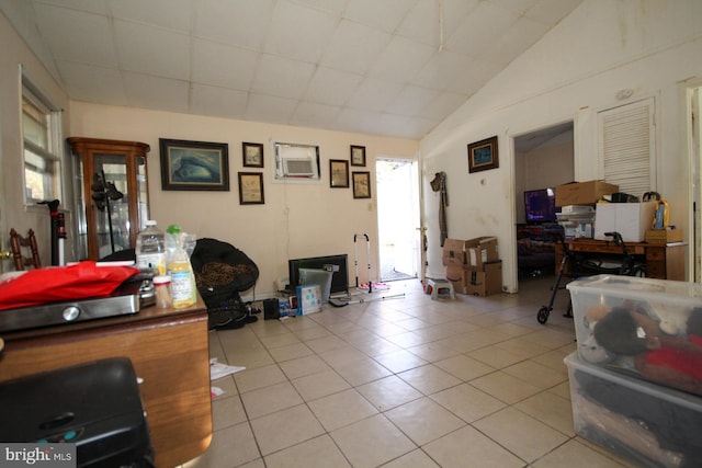 interior space featuring vaulted ceiling and light tile patterned flooring