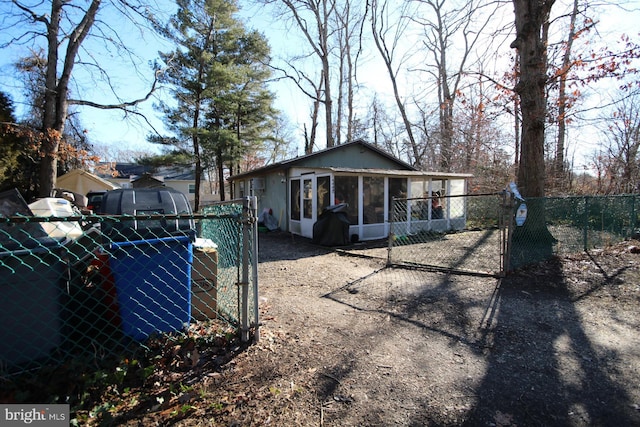 back of property with a sunroom