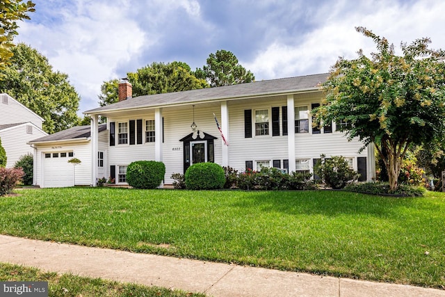 bi-level home with a garage and a front yard