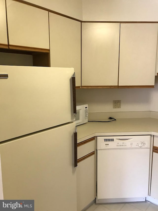 kitchen featuring white cabinetry and white appliances