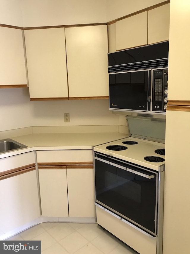 kitchen with white range with electric cooktop and sink