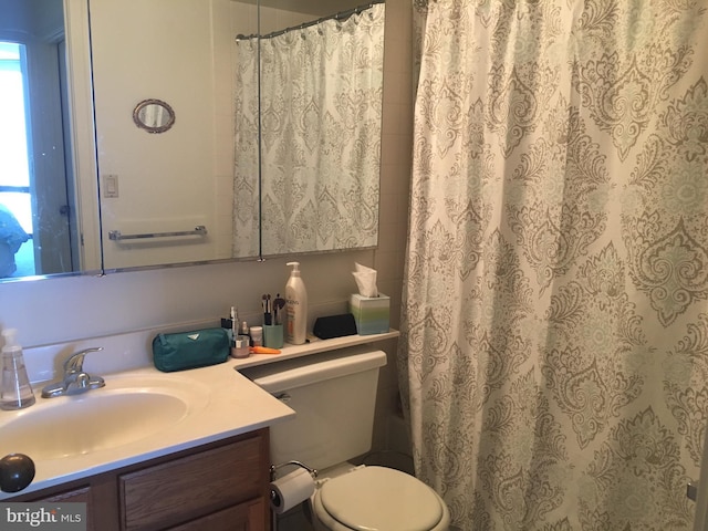 bathroom featuring vanity, toilet, and walk in shower