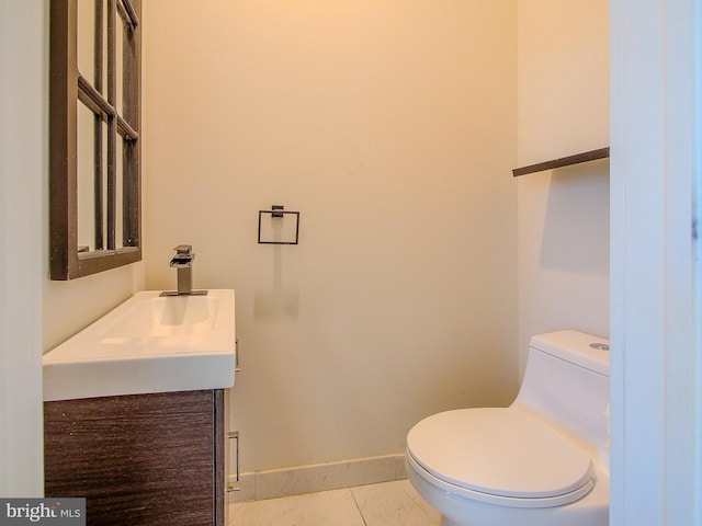 bathroom featuring vanity, tile patterned flooring, and toilet